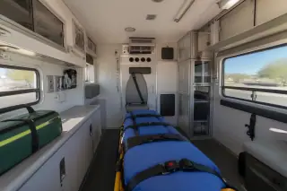 Wide view of a transport vehicle interior with secured medical equipment and cabinetry in Phoenix, AZ.