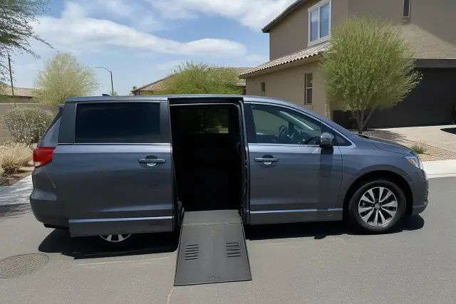 Medical transport vehicle at a curbside pickup in Avondale, AZ with sliding doors open for passenger assistance.