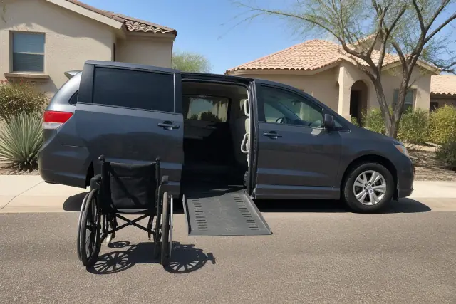 Medical transport vehicle with open side doors for boarding assistance parked curbside in Tempe, AZ.