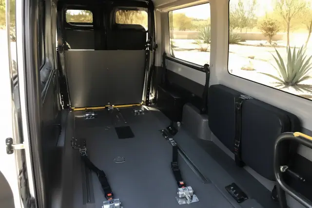 Wheelchair securement station with floor tracking and tie-down straps in a bariatric transport vehicle in Phoenix, AZ.