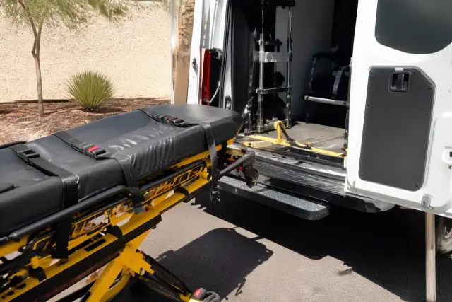 A medical stretcher secured to a transport vehicle for loading in Phoenix, AZ.