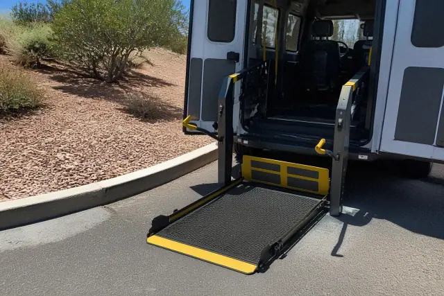 Automated hydraulic ramp lowered to ground level for mobility access on a desert jobsite in Phoenix, AZ.