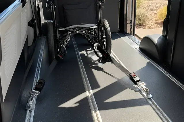 Four-point tie-down straps secured to a floor tracking system for a mobility device in a vehicle in Phoenix, AZ.