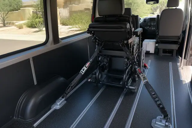 Bariatric patient transport equipment secured with heavy-duty tie-down straps in a vehicle in Phoenix, AZ.