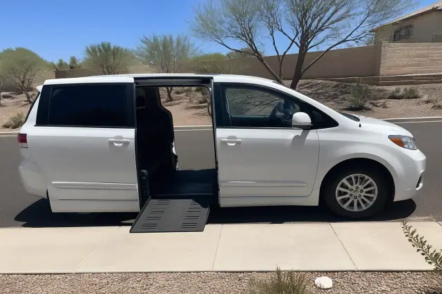 Medical transport vehicle with open side doors for passenger boarding at a curbside in Phoenix, AZ.