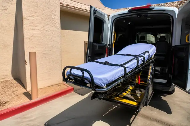 Stretcher secured at the rear of a dialysis transport vehicle during loading in Phoenix, AZ.