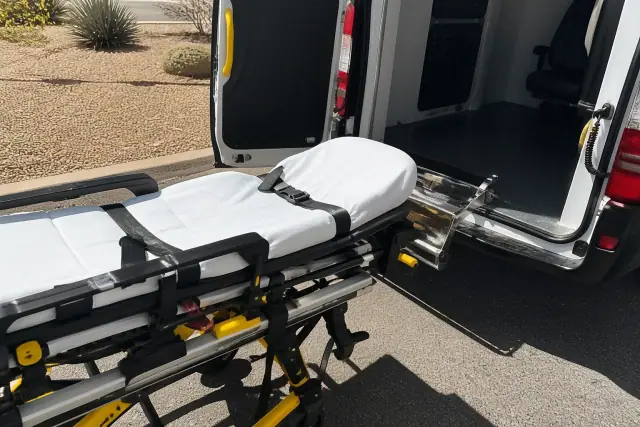 Stretcher loaded into a medical transport vehicle at a job site in Sun City, AZ.