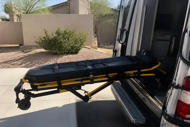 Stretcher secured at the back of a medical transport vehicle during loading in Surprise, AZ.