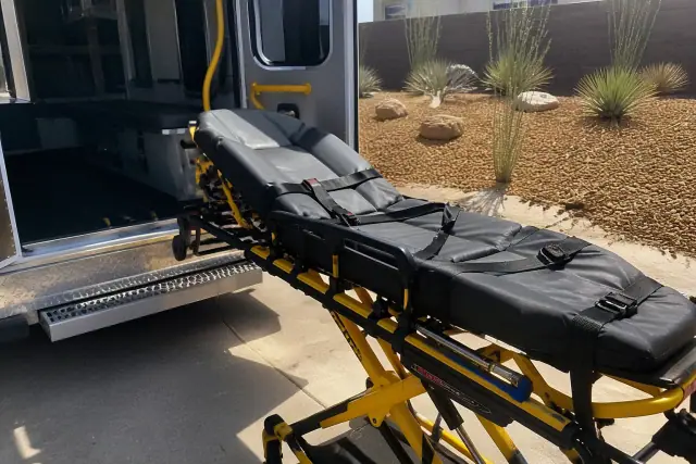 Stretcher secured at the back of a medical transport vehicle during loading in Avondale, AZ.