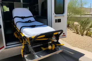 Stretcher secured with safety belts and locking mechanism in a transport van in Phoenix, AZ.