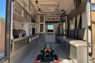 Stretcher transport vehicle cabin with secured medical equipment and interior safety restraints in Phoenix, AZ.