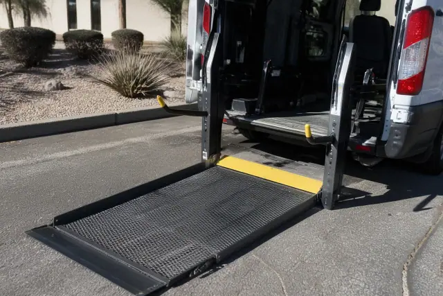 Automated hydraulic lift ramp deployed on a wheelchair-accessible transport vehicle in Phoenix, AZ.
