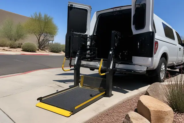 Hydraulic lift ramp lowered for wheelchair access on a hospital transport vehicle in Phoenix, AZ.