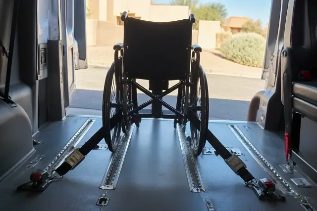 Wheelchair transportation van interior with tie-down straps and floor tracking systems in Glendale, AZ.