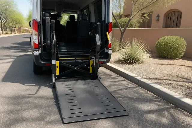 Automated hydraulic wheelchair ramp lowered to the ground at a stucco building in Phoenix, AZ.