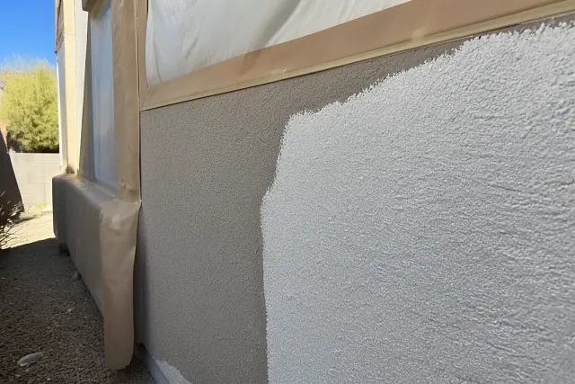 Acrylic coating being applied to a textured stucco wall at a home in Phoenix, AZ.