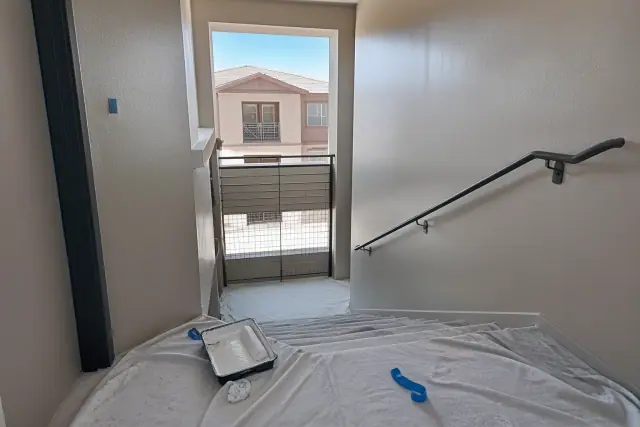 Freshly painted interior stairwell with drop cloths in a Phoenix, AZ apartment complex.