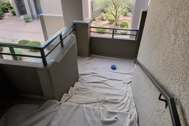 Canvas drop cloths on an interior apartment stairwell during a painting project in Mesa, AZ.