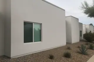Freshly painted stucco exterior wall with agave plants at a Phoenix, AZ apartment building.