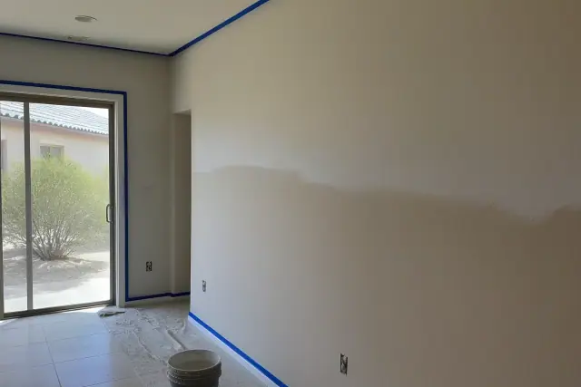Back-rolled paint texture on residential walls in a Phoenix, AZ home with taped trim and desert views.