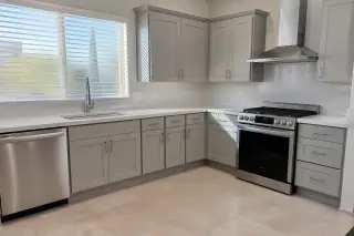 Finished kitchen cabinets with a desert view through the window in a Phoenix, AZ home.