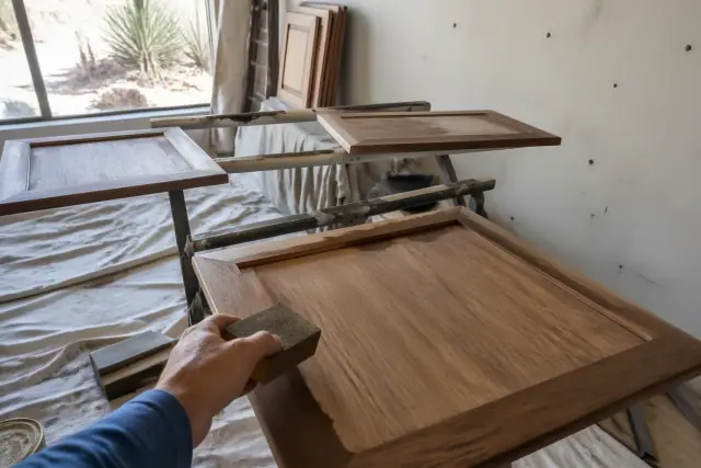 Cabinet doors drying on racks in a Phoenix, AZ workshop during a kitchen refinishing project.