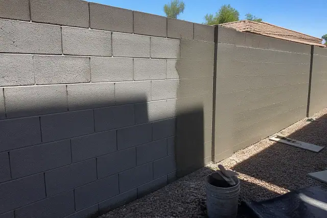 Half-finished masonry coating on a concrete block wall at a job site in Phoenix, AZ.