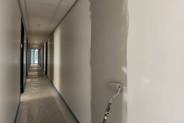 Fresh paint being applied to a commercial office hallway in Tempe, AZ.