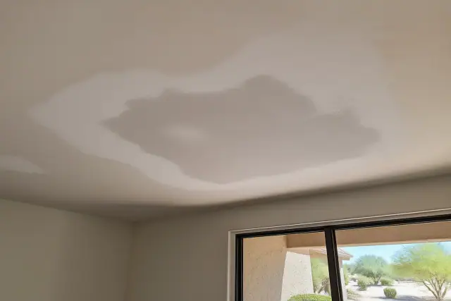 Sanded drywall ceiling patch in a Phoenix, AZ home, showing repair progress after popcorn ceiling texture removal.