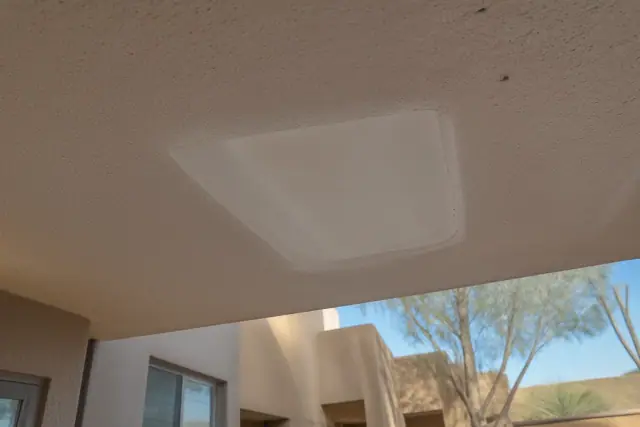 Sanded drywall patch on a textured ceiling during a repair project in Phoenix, AZ.