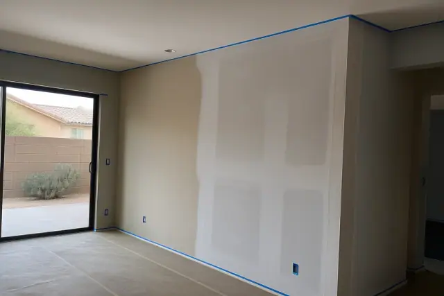 Drywall repair and painting in a residential living room in Gilbert, AZ.