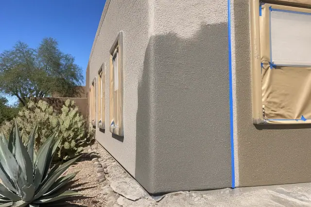 Fresh exterior stucco painting in progress on a textured wall at a jobsite in Phoenix, AZ.