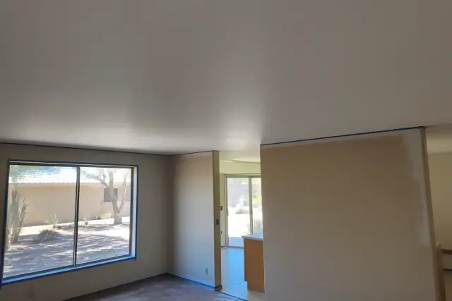 Smooth flat ceiling after popcorn removal in a residential living space in Phoenix, AZ.