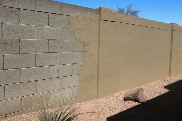 Half-finished masonry coating on a concrete block wall in Phoenix, AZ.