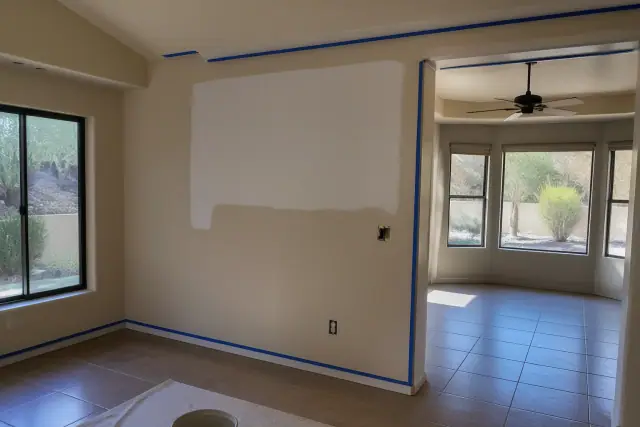 Interior painting in progress with taped trim and fresh wall color in a Phoenix, AZ home.
