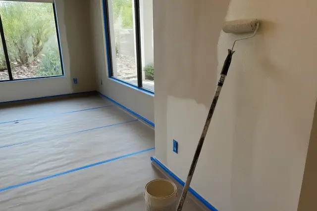 Interior painting in progress with taped trim and paint supplies in a home in Paradise Valley, AZ.