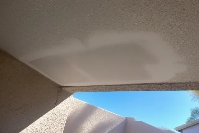 Sanded drywall repair patch on a ceiling in Phoenix, AZ, prepared for primer and paint.