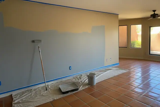 Low-VOC acrylic paint being applied to a living room wall at a residential jobsite in Phoenix, AZ.