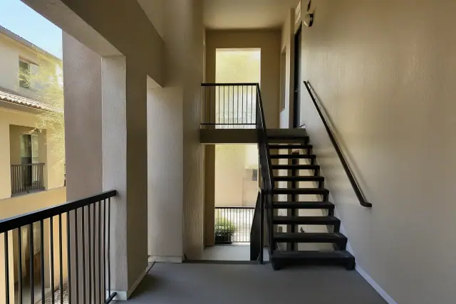Freshly painted apartment stairwell with crisp trim and smooth walls in a residential complex in Phoenix, AZ.