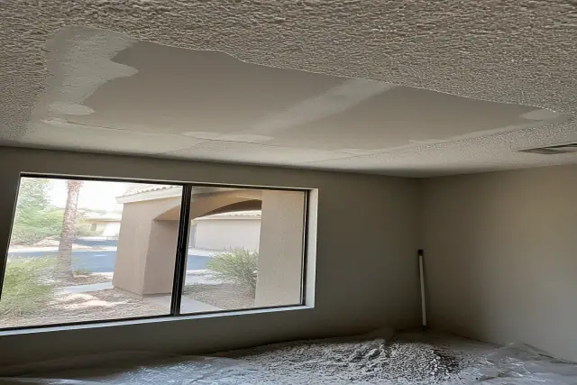 Drywall ceiling repair and popcorn texture removal on a drop cloth in a home in Surprise, AZ.