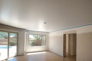 Smooth, flat ceiling in a Phoenix, AZ living room after professional popcorn ceiling removal.