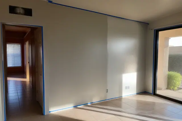 Interior painting showing matte and satin wall sheens on taped off stucco walls in a Phoenix, AZ home.