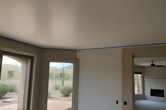 Smooth ceiling after popcorn removal in a residential living space in Phoenix, AZ.