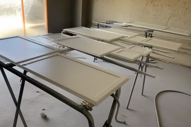 Cabinet doors on drying racks during an interior painting project in Phoenix, AZ.