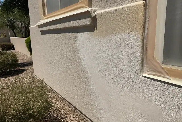 Stucco repair and fresh paint on a residential exterior wall in Phoenix, AZ.