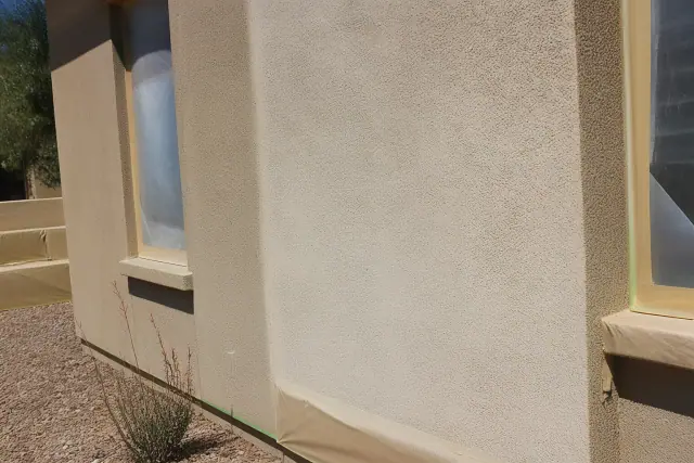 UV fading on a sun-bleached stucco exterior wall during a construction project in Phoenix, AZ.