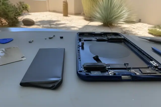 New battery and open smartphone chassis during repair in Phoenix, AZ.
