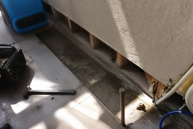 Water damage repair showing sink spill evidence on a residential floor in Phoenix, AZ.