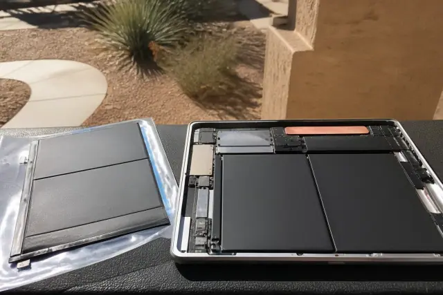 Replacement battery for an iPad and tablet repair on a workbench in Phoenix, AZ.