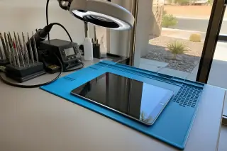 Finished iPad resting on a sunlit workbench with precision tools in Phoenix, AZ.